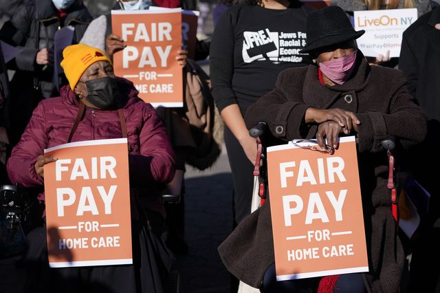 People rally in support of living wages for home care workers in New York City, December 14, 2021